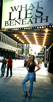 Barefoot Becca shows her bare sole under the What Lies Beneath marquee on Broadway